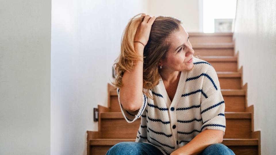 Perimenopause Acne hero image of a woman looking to the side.