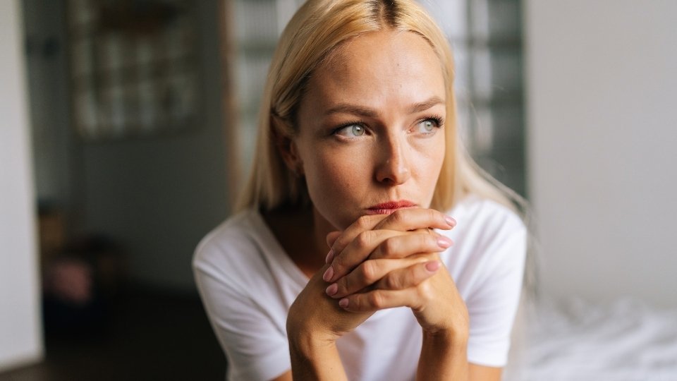 Sermorelin Side Effects What to Expect hero image of a woman thinking about possible side effects.
