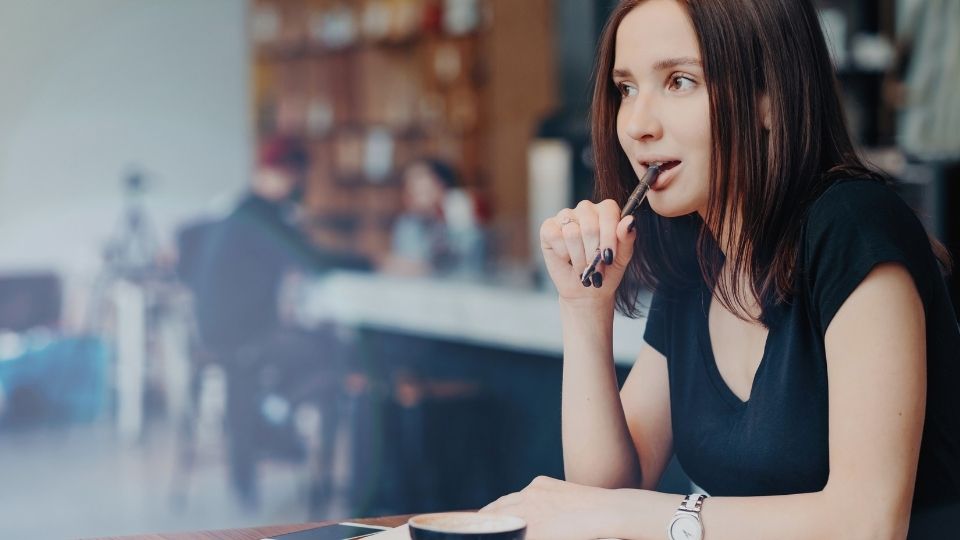 what signals the end of menopause a woman puts a pen in her mouth while thinking of the answer.