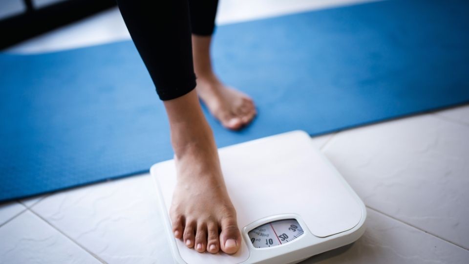 Online Semaglutide Prescription hero image of a woman on a scale.